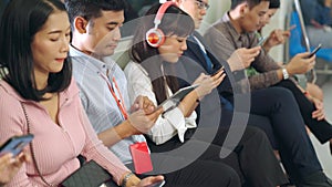 Young people using mobile phone in public underground train