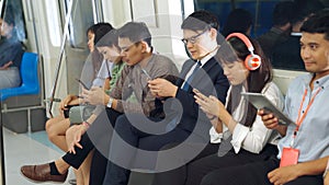 Young people using mobile phone in public underground train