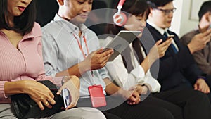 Young people using mobile phone in public underground train