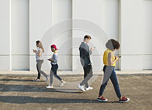 Young people using smartphones outdoors