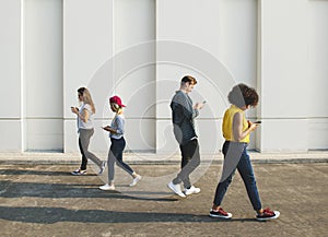 Young people using smartphones outdoors photo