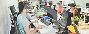 Young people using virtual reality glasses in coworking office - Teamwork creating new digital contents - Technology trends,