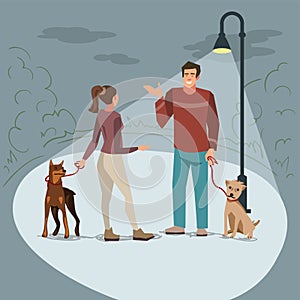 Young people walk in the park with their dogs in the evening when lighted lanterns