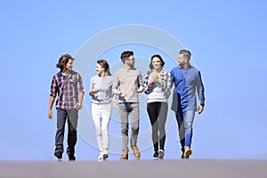 Young people walking along the road.