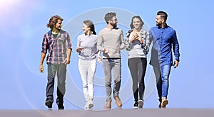 Young people walking along the road.