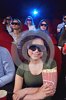 Young people watching 3D film at the movie theatre