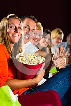 Young people watching 3d movie at cinema