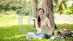 Young people work from home with laptop and drinking coffee in morning relax at nature garden home.