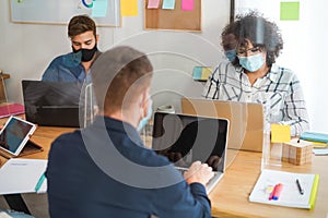 Young people working inside modern office behind plexiglas - Focus woman face