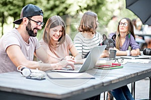 Young people working at the outdoor cafe