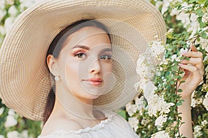 Young perfect female model girl with clear skin and flowers