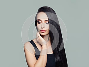 Young perfect woman with long dark straight hair and makeup portrait