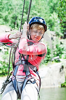 Young perfect woman sliding on a zip line