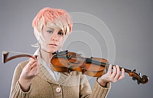 Young performer woman playing the violin.