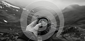 a young person hand holding a compass full of mountains