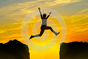 Young person jumping over the mountains