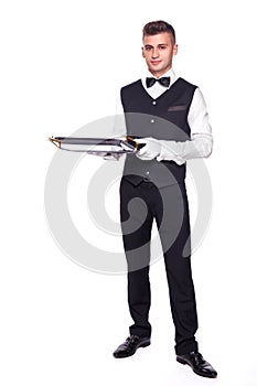 Young person in a suit holding an empty tray isolated on white b