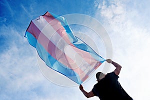 Young person with a transgender pride flag photo