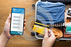 Young person using  credit  cards with smartphone for payment coronavirus insurance before go travel.health and financial