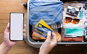 Young person using  credit  cards with smartphone for payment  ticket or booking hotel. convenient  lifestyle with technology. photo