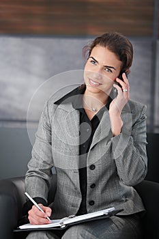 Young personal assistant using mobile smiling