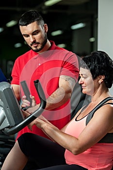 Brunette woman working out with personal coach