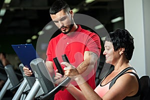 Brunette woman working out with personal coach