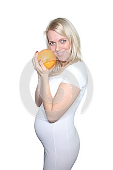 Young Petty Natual Beauty Pregnant Woman Holding Grapefruit and Shows a Belly That Begins to Grow Isolated on White Background.
