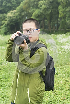 Young photographer in field
