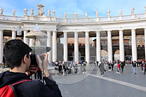 young photographer in Saint Peter Square in Vatican City