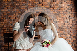 Young photographer shows the bride had just taken photos