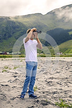 Young photographer is taking a picture in Norway