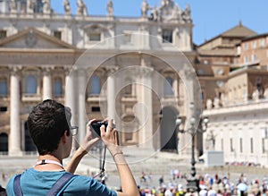 Photographer while taking a picture at Square of Saint Peter in