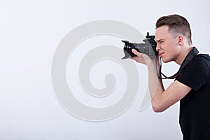 Young photographer on white background