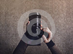 Young Photographer Woman using Camera to Taking Photo. Dark Tone, POV or Top View in Low Angle.