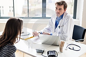 Young physician listening to his patient with respect and dedication photo