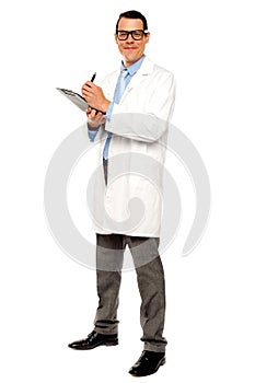 Young physician writing medical report