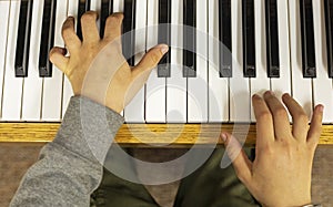 Young pianist playing piano waltz with two hands, Flatlay