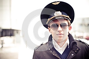 Young pilot in Kastrup airport against terminal, c