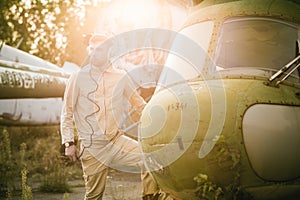 Young pilot posing near the helicopter