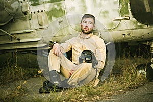 Young pilot posing near the helicopter