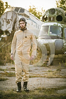 Young pilot posing near the helicopter