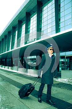 Young pilot walking with baggage in Kastrup airpor