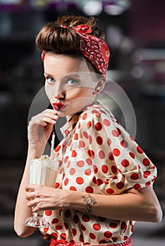 young pin up woman drinking milkshake