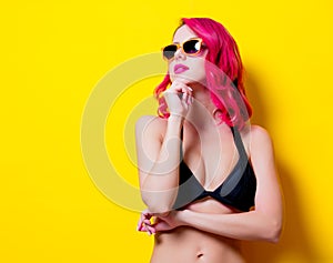 Young pink hair girl in bikini and orange glasses