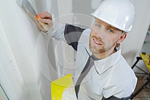 Young plasterer at work