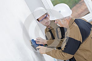 Young plasterer working on indoor wall