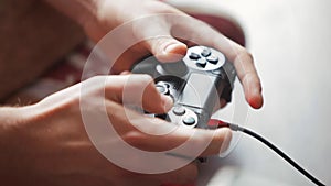 Young Player Gamer Man Hands playing Video Games on Console with Joystick