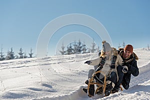 Young playful couple having fun in the snow