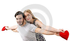 Young playful involved couple posing as flying